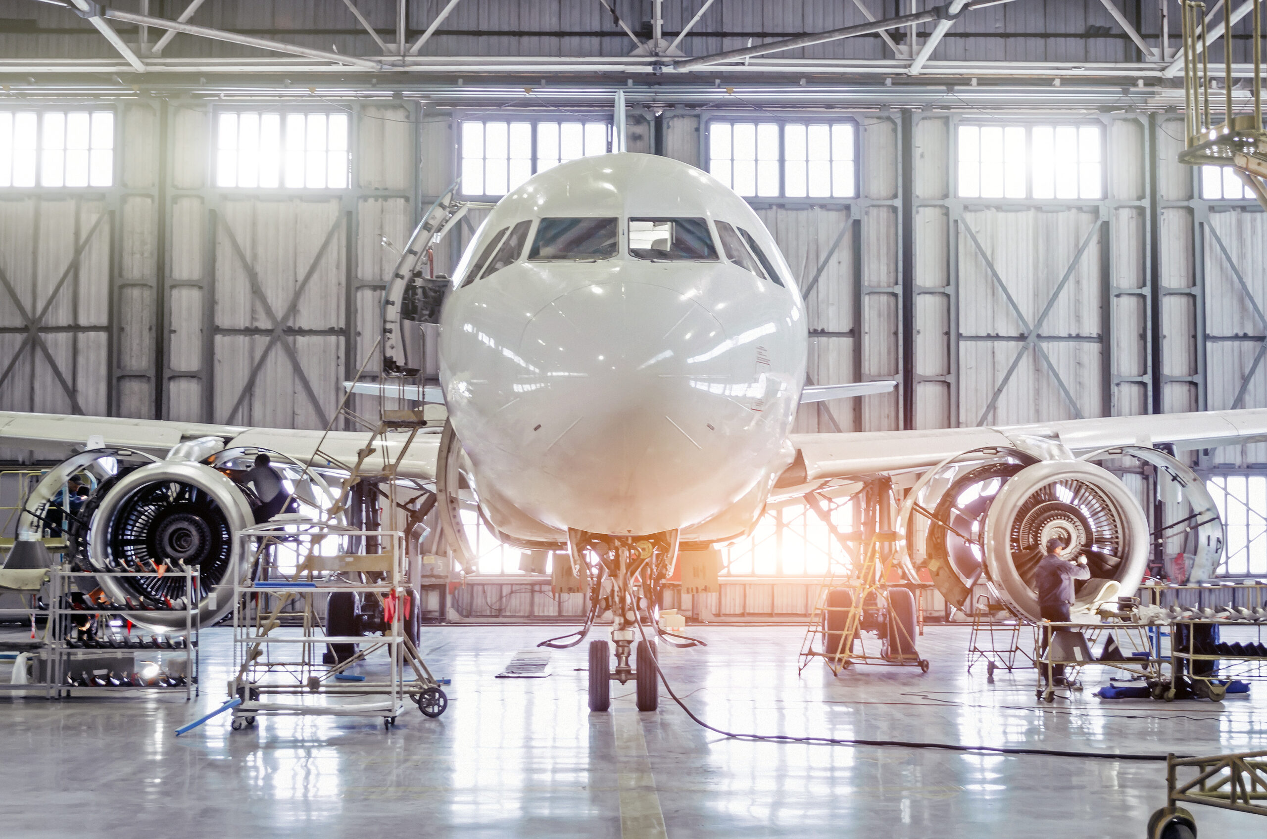 Passenger aircraft on maintenance of engine and fuselage repair in airport hangar